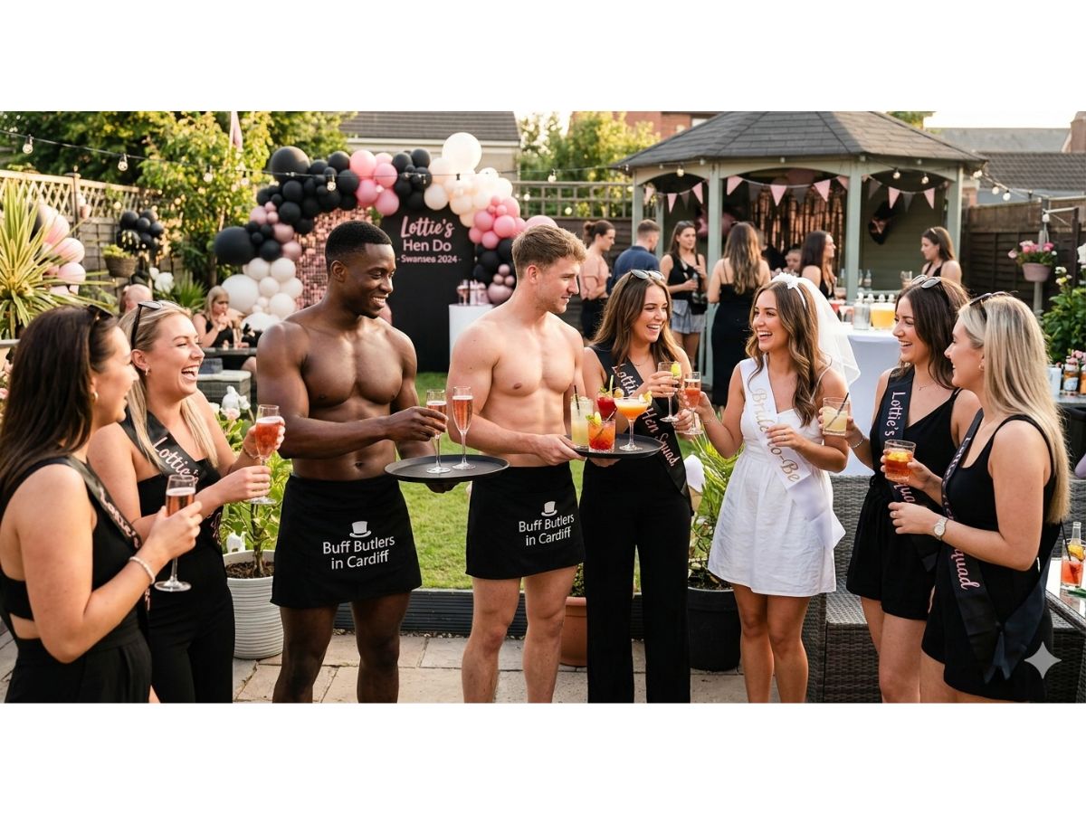 Two shirtless butlers in the buff serving cocktails to a bride and her friends at a lively garden hen party event in Monmouth